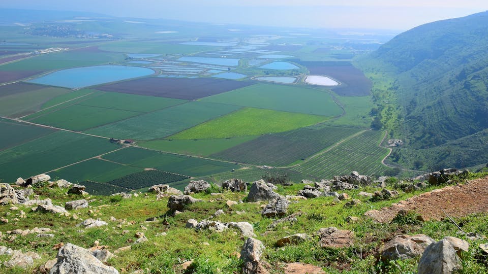 landscape with a view on Jezreel Valley ( Valley of Megiddo ) from Mount Gilboa. plowed land, colorful fields, fish ponds. Lower Galilee region in Israel