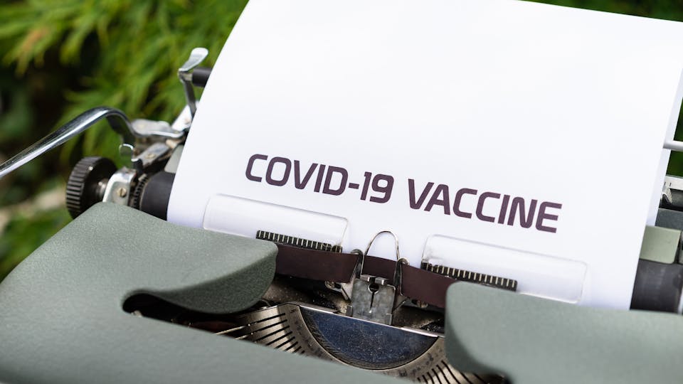 Covid-19 Vaccine written on paper