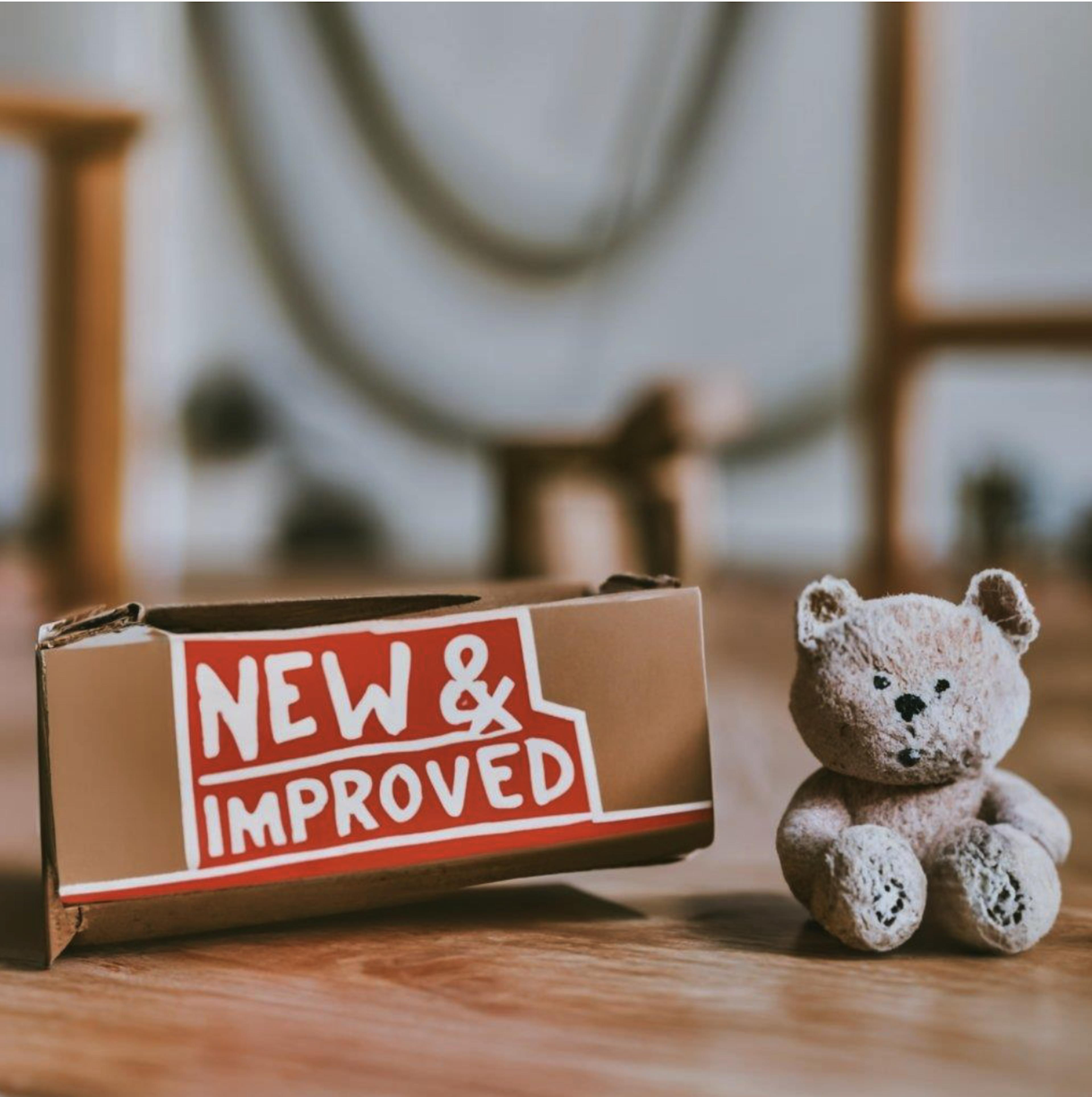 A box that says "new & improved" and a teddy bear