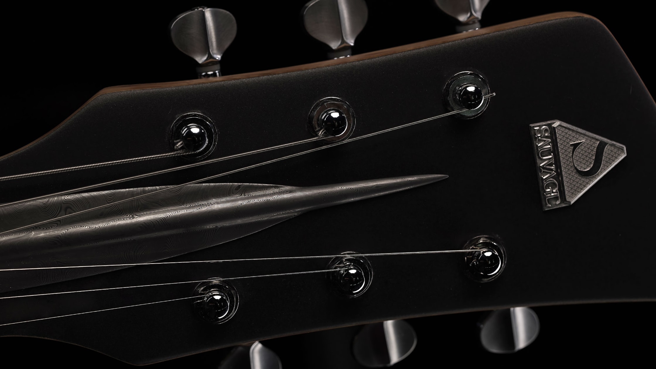 headstock with the Sauvage brand logo on the One piece master I guitar