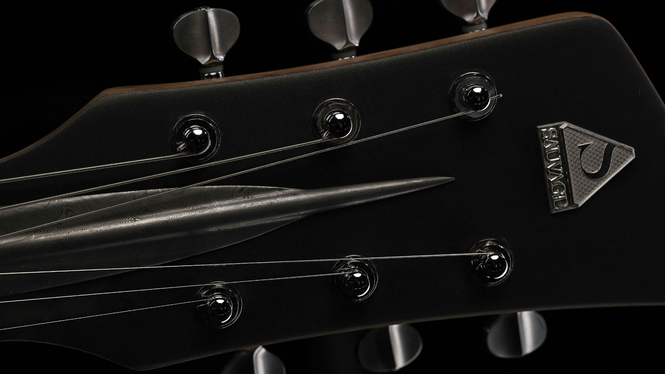 headstock with the Sauvage brand logo on the One piece master I guitar