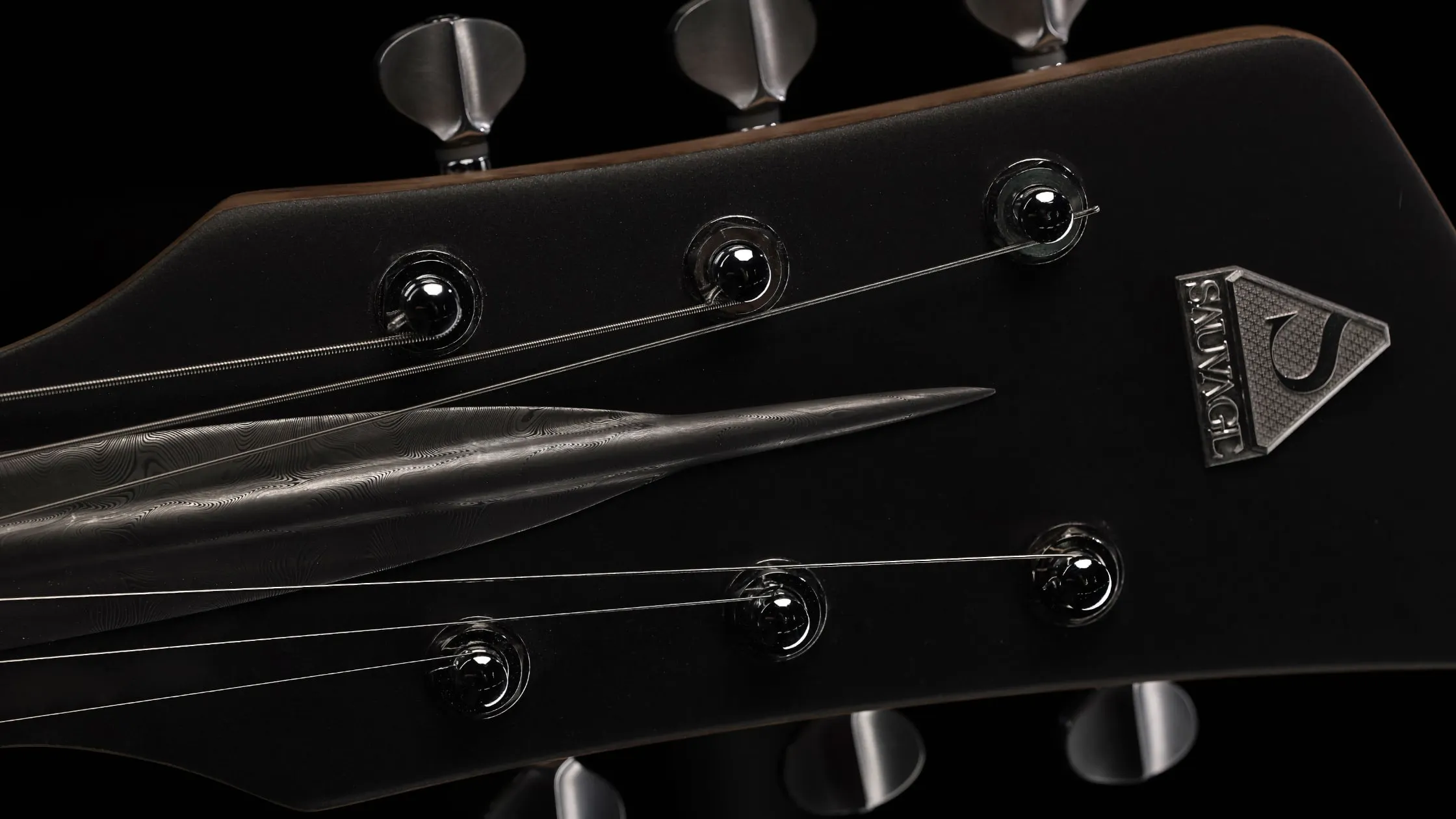 headstock with the Sauvage brand logo on the One piece master I guitar