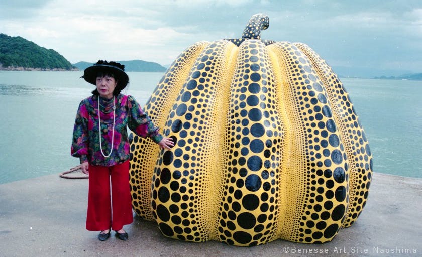 Yayoi Kusama standing next to Pumpkin (1994) on the 15th of September 1994, during her visit for the opening reception of the Out of Bounds exhibition.