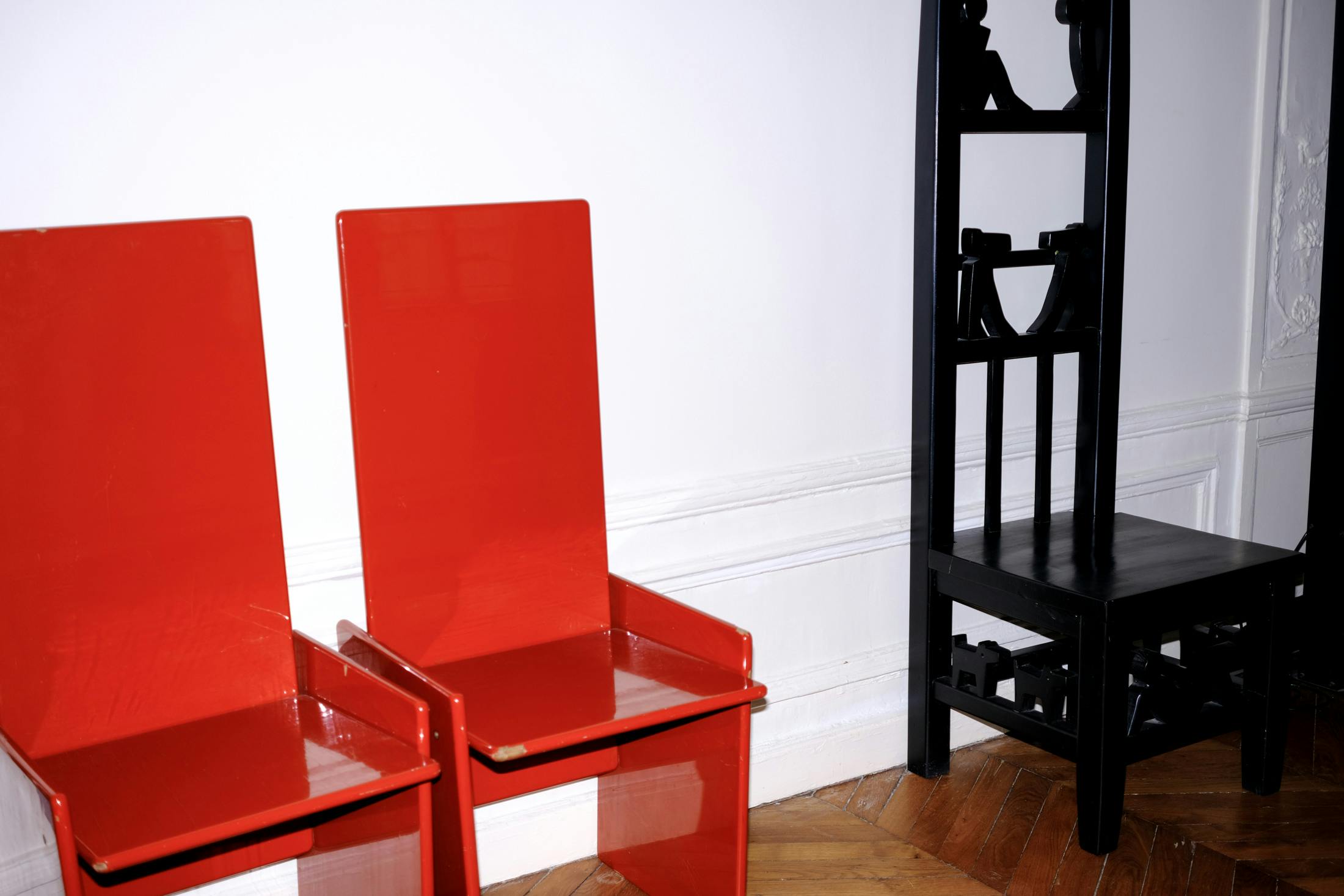 Red lacquered chairs in Rooms Studio's Paris Outpost Apartment | Photo by Kristen de La Vallière