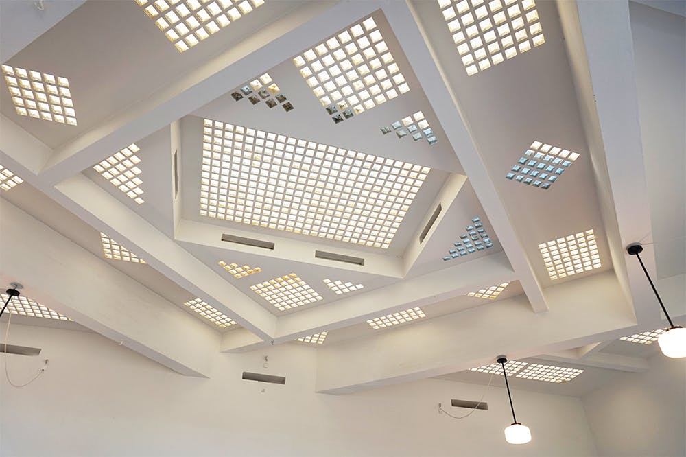 The ceiling was partially constructed from glass bricks, creating a striking geometric composition.