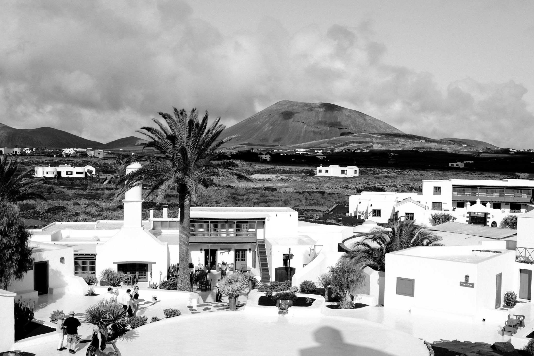 The location is chosen for its significance in preserving the island's agricultural heritage, and the surrounding landscape reflects Lanzarote’s unique volcanic terrain, which is integral to its cultural identity