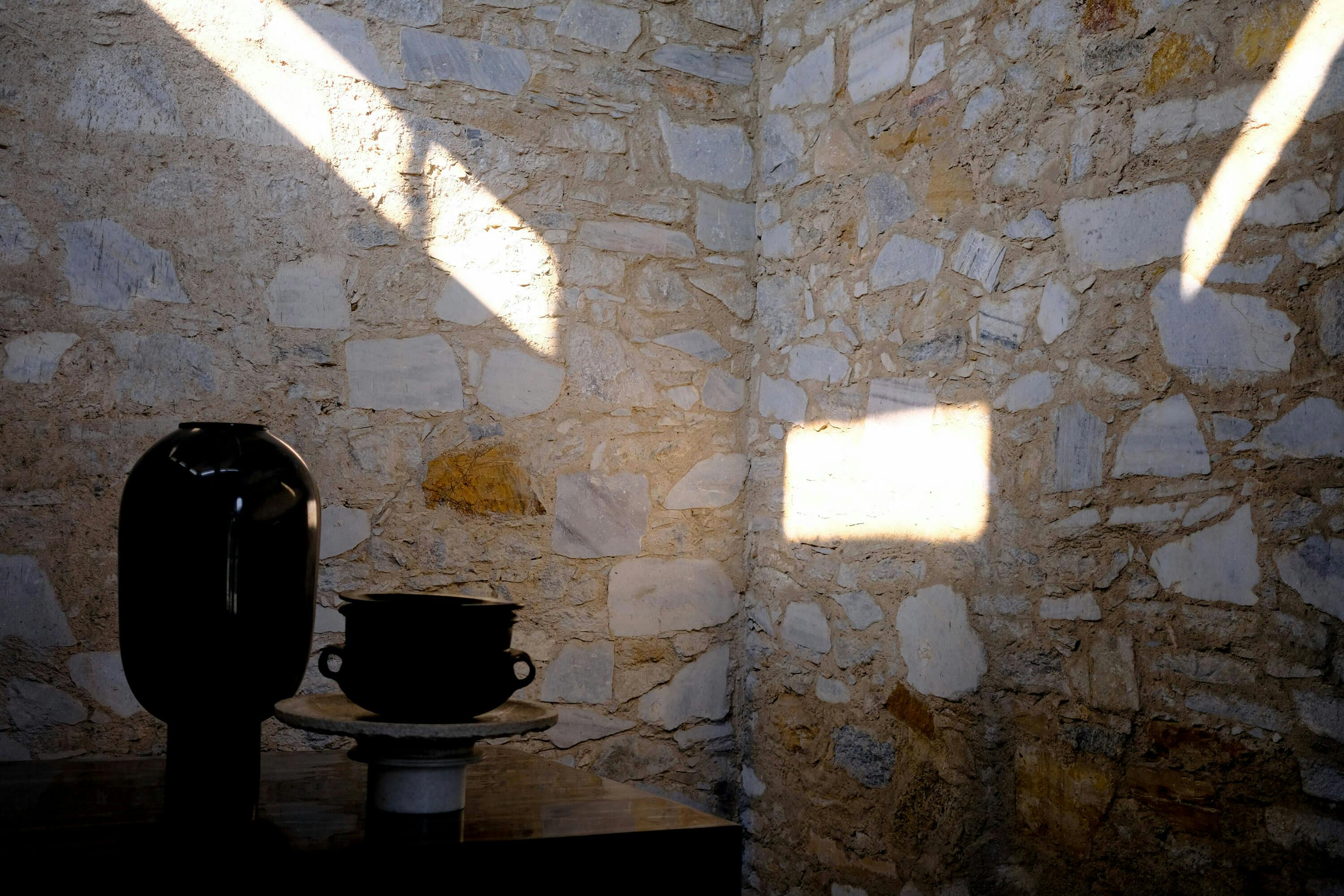 Light on the walls and vases in the Makrana, Rajasthan, India home of Studio Raw Material