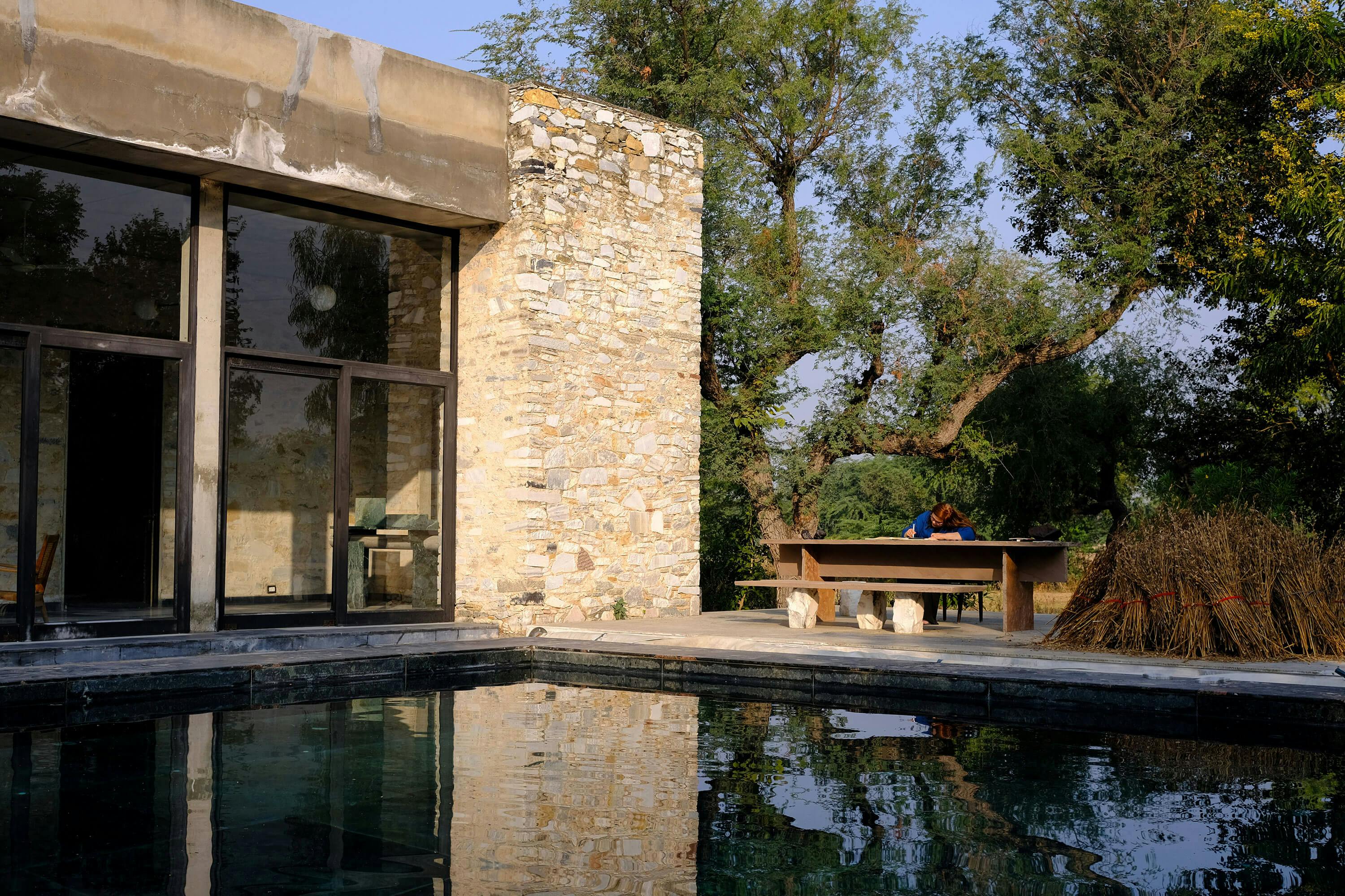 Priyanka Sharma sketching outdoors at Studio Raw Material’s home in Makrana, Rajasthan — a region known for its storied marble and vernacular architecture.