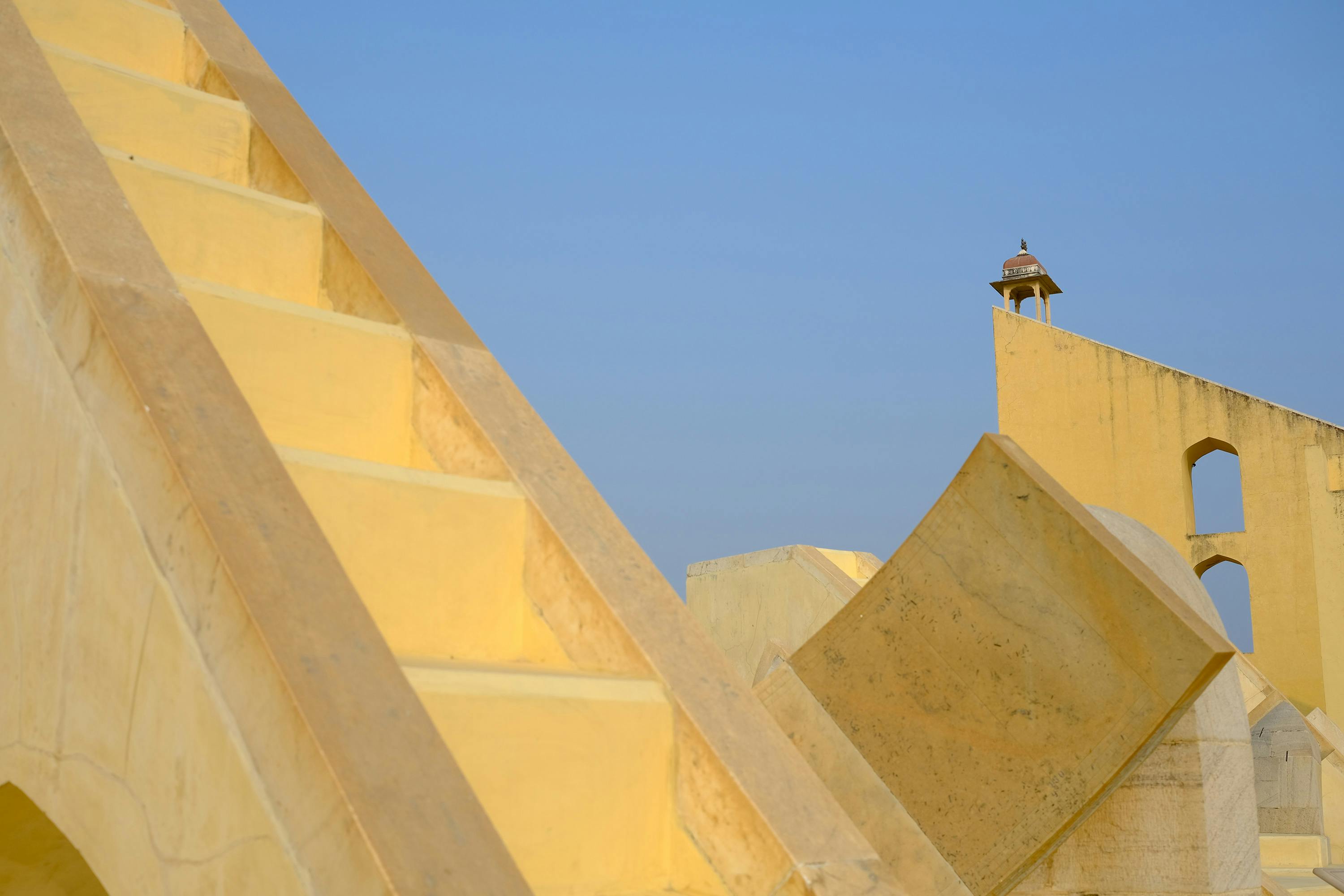 Jantar Mantar astronomical observatory in Jaipur, India, featuring historic stone instruments used for measuring time, tracking celestial bodies, and observing astronomical phenomena.