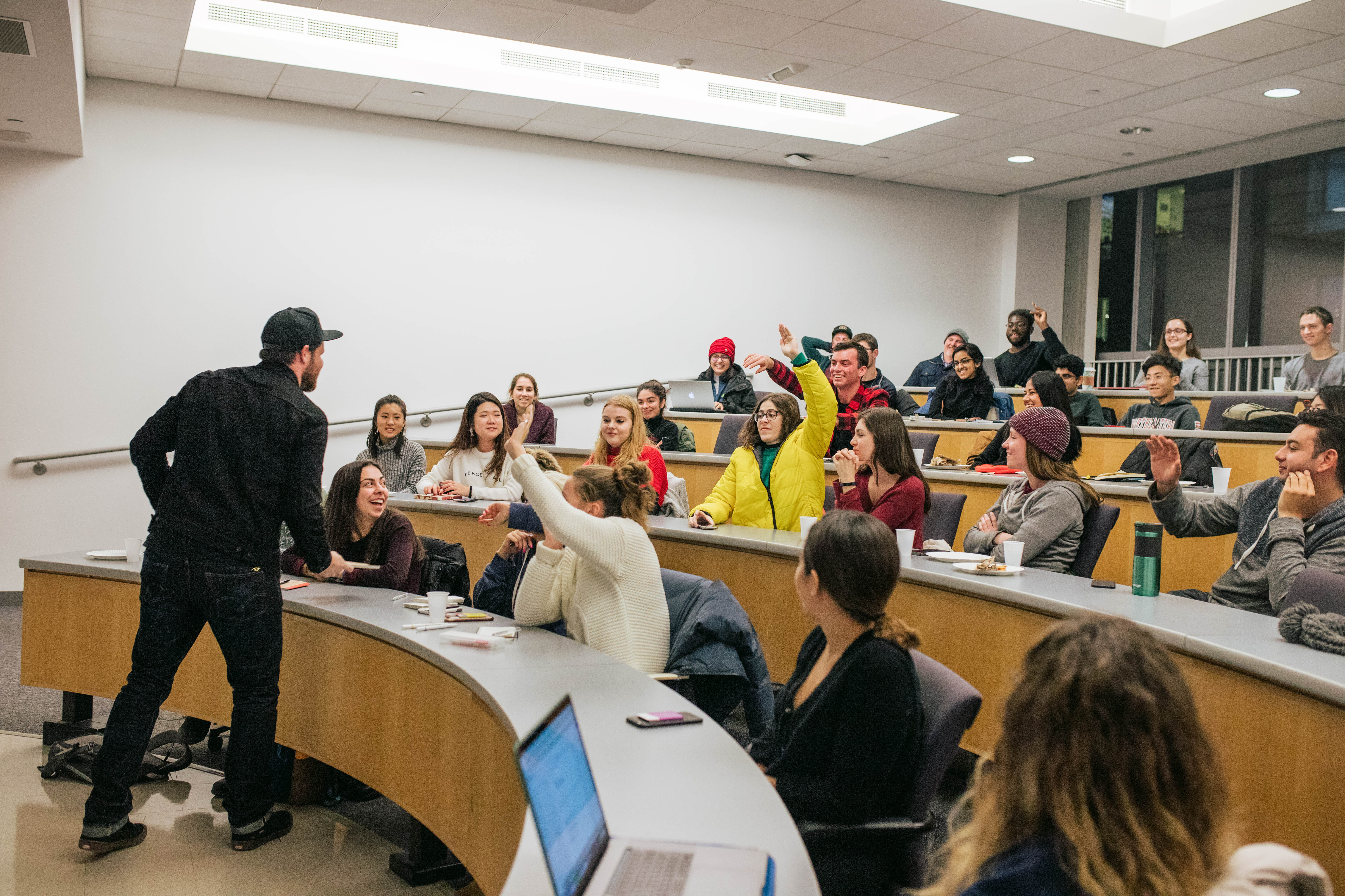 Students raise their hands during a Scout event