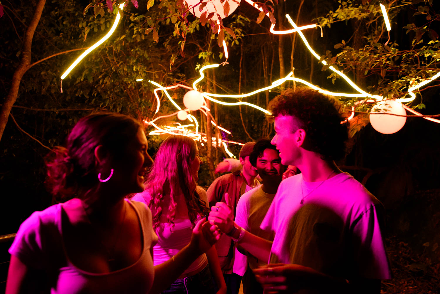 Group of young adults under lights