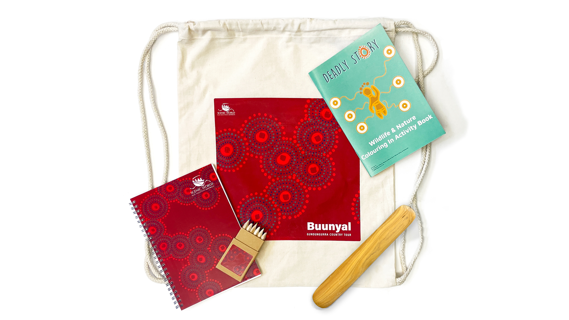 A drawstring bag containing a red spiral-bound notebook with circular patterns, a pack of coloured pencils, a wildlife and environment activity book, and a wooden stick.