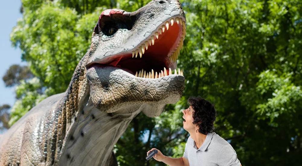 Andy Day looking at a T-Rex
