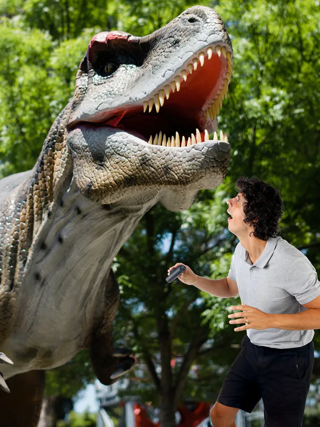 Andy Day looking at a T-Rex