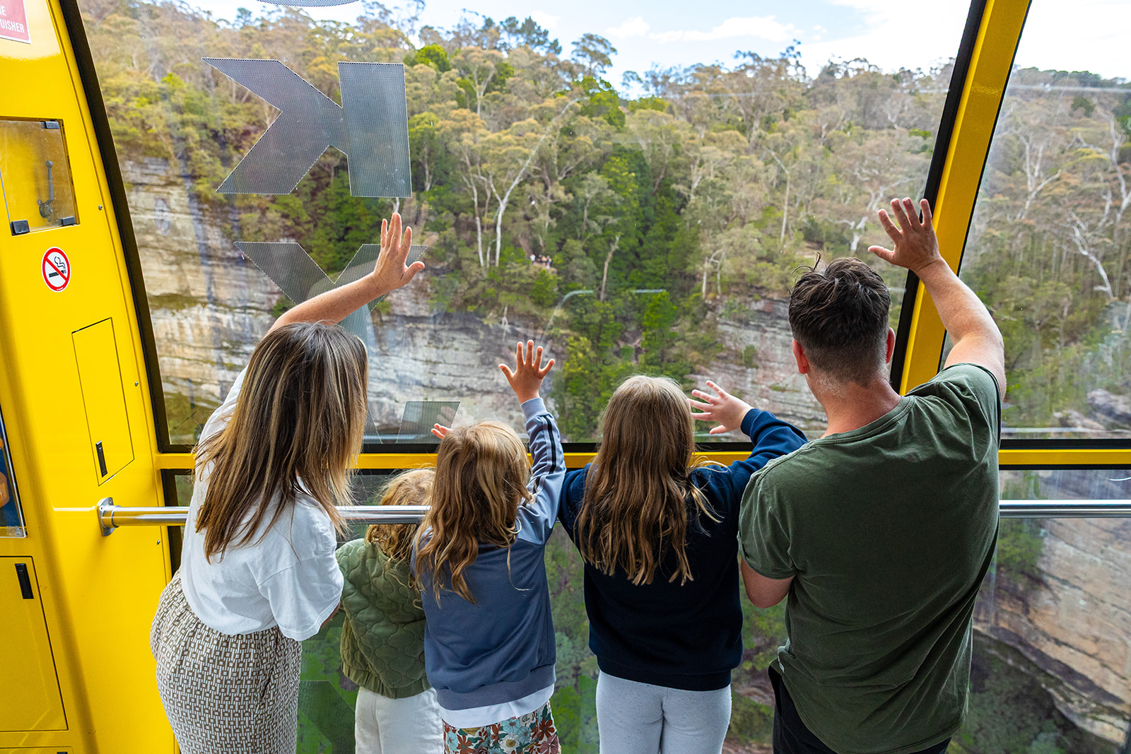 Family waving on the Scenic Skyway
