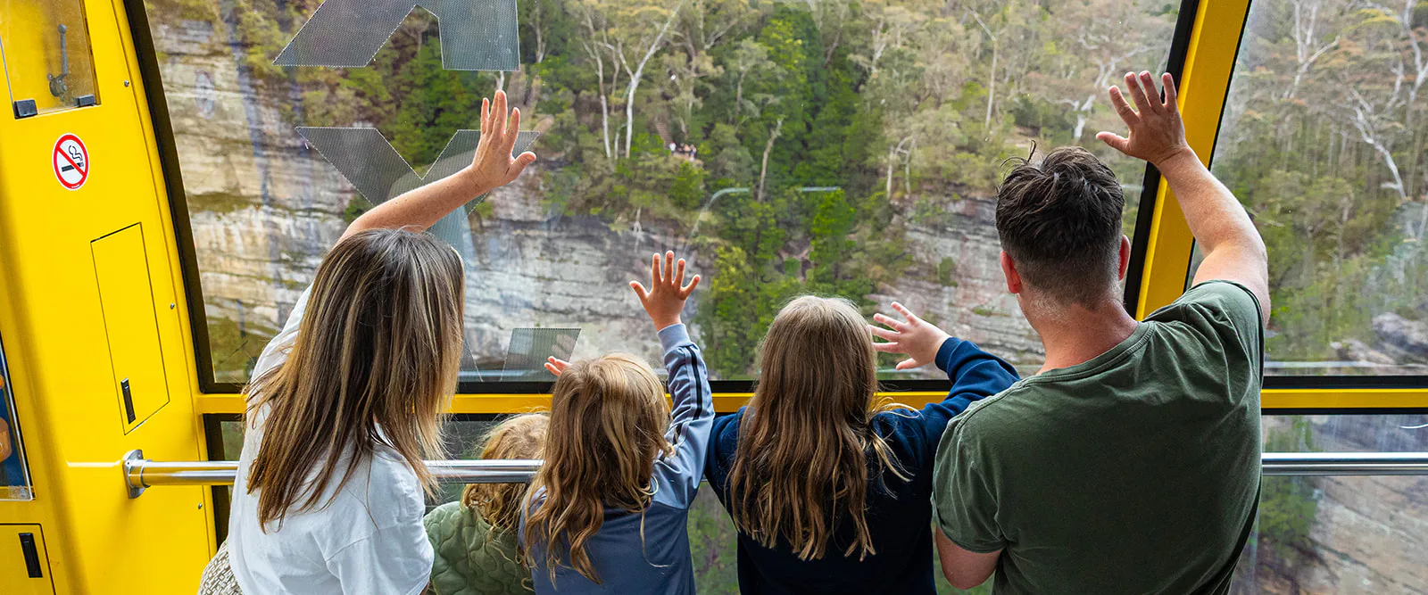Family waving on the Scenic Skyway
