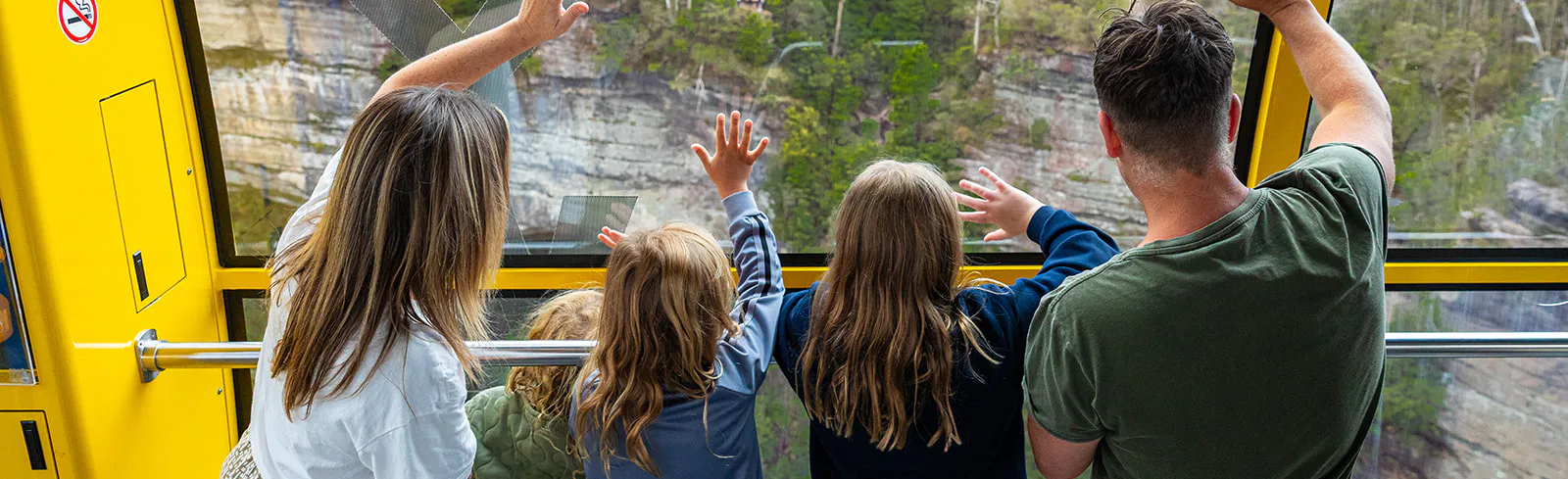 Family waving on the Scenic Skyway