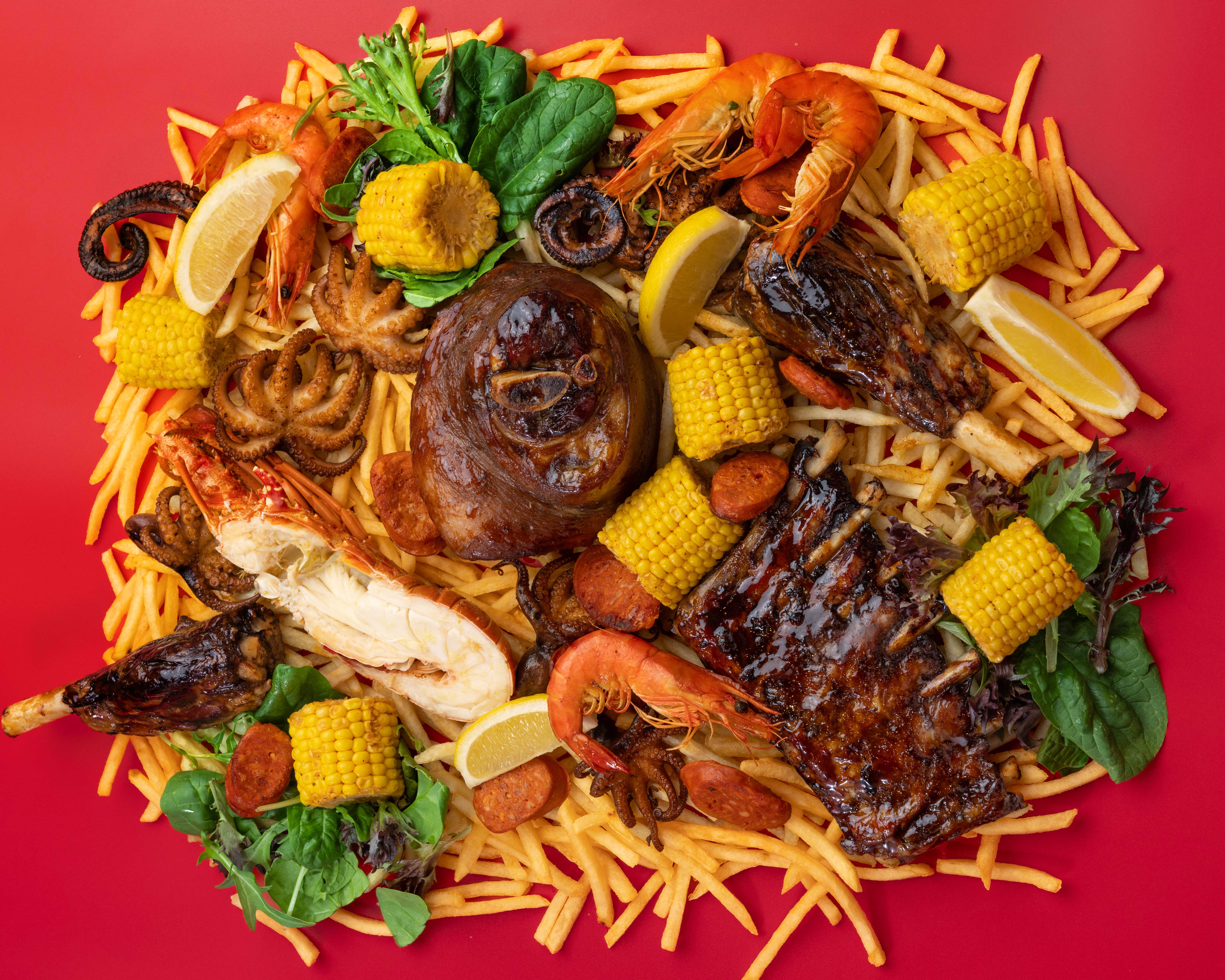 An assortment of meat lobster corn and chips