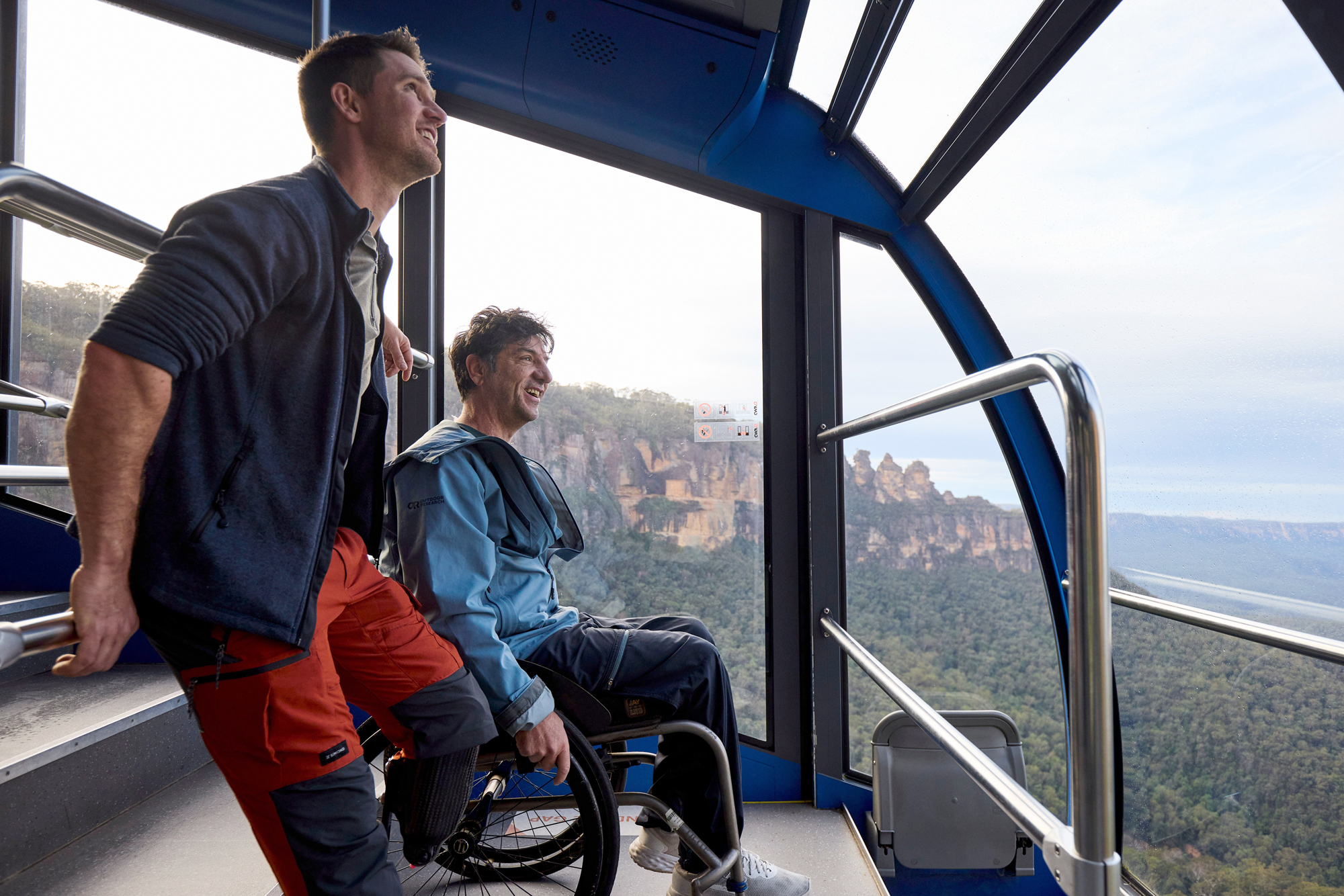 Two men on the Scenic Cableway. One in wheelchair, one with prothesis