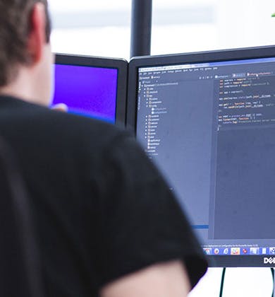 Man coding on a computer