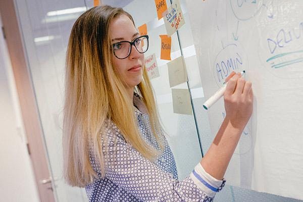 Woman writing on a whiteboard