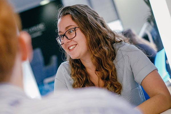 Woman smiling in a group discussion