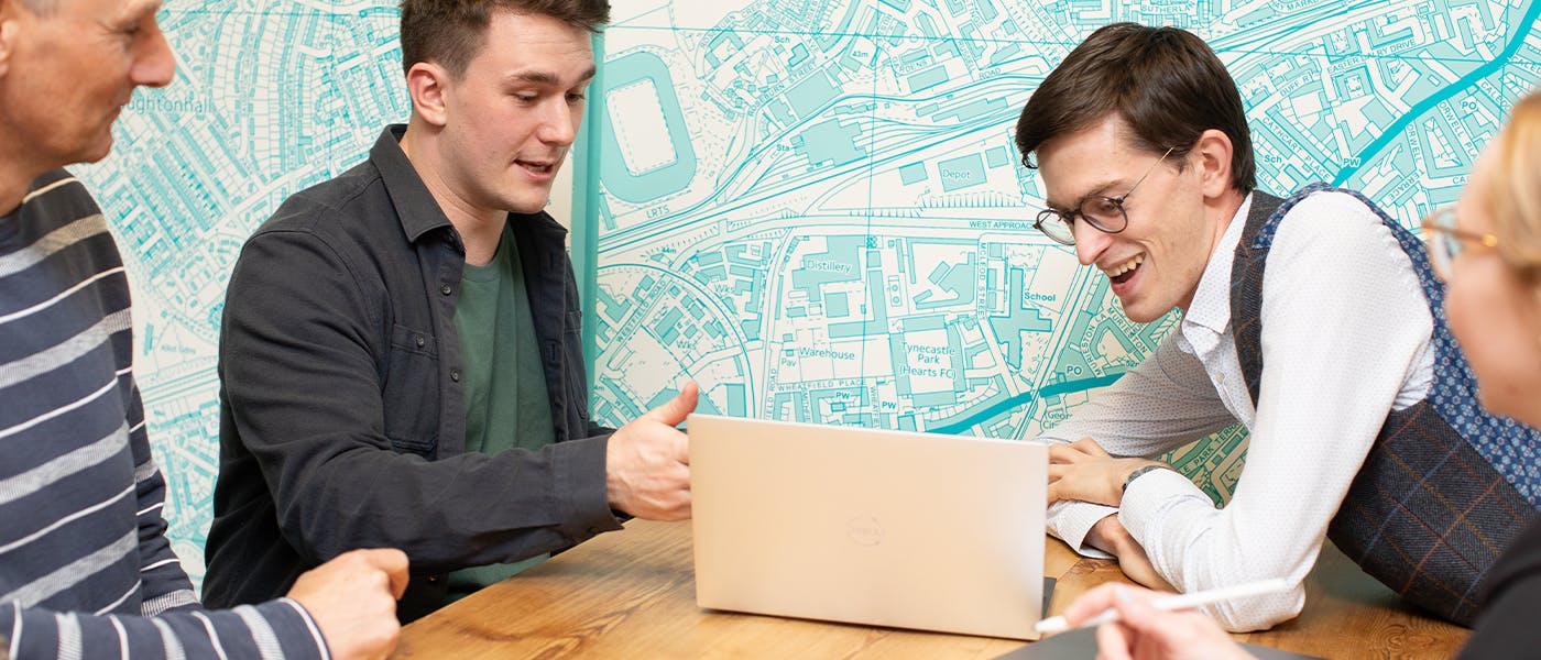 People working over a laptop