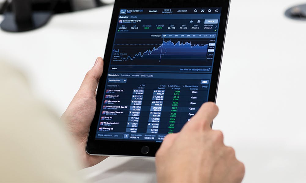 Person holding a tablet that is displaying a graph