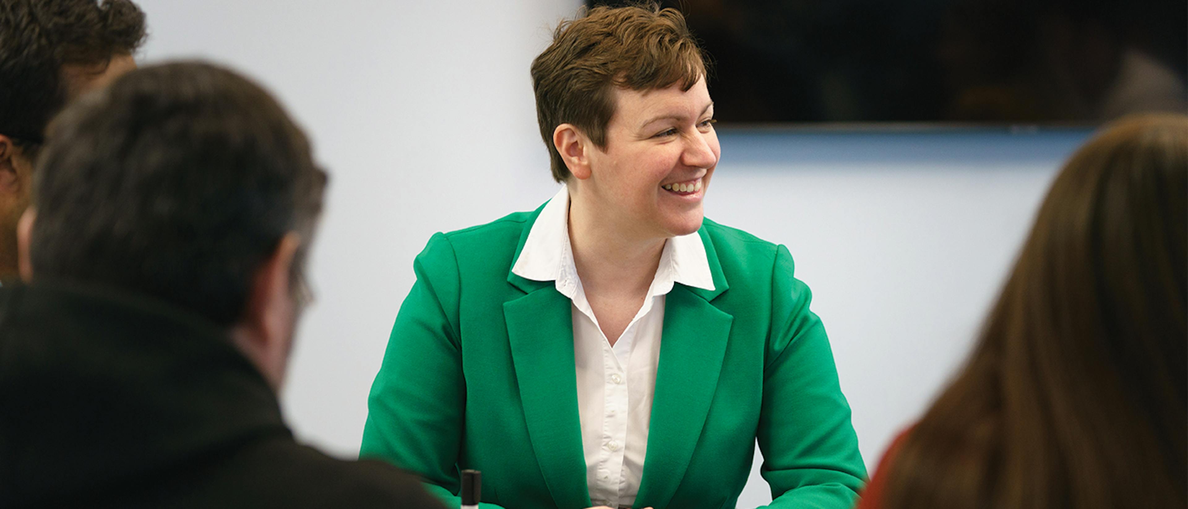 Person smiles in meeting