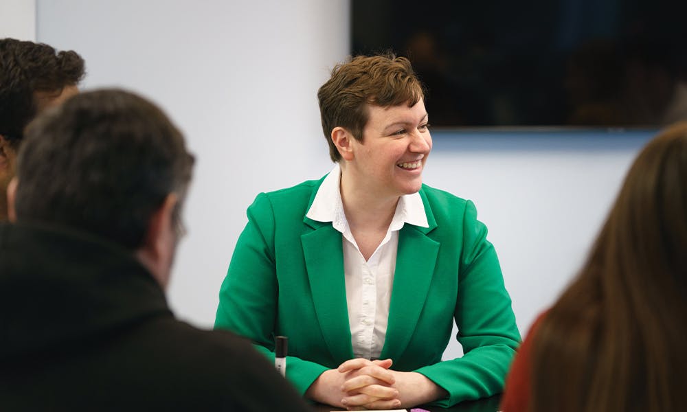 Person smiles in meeting