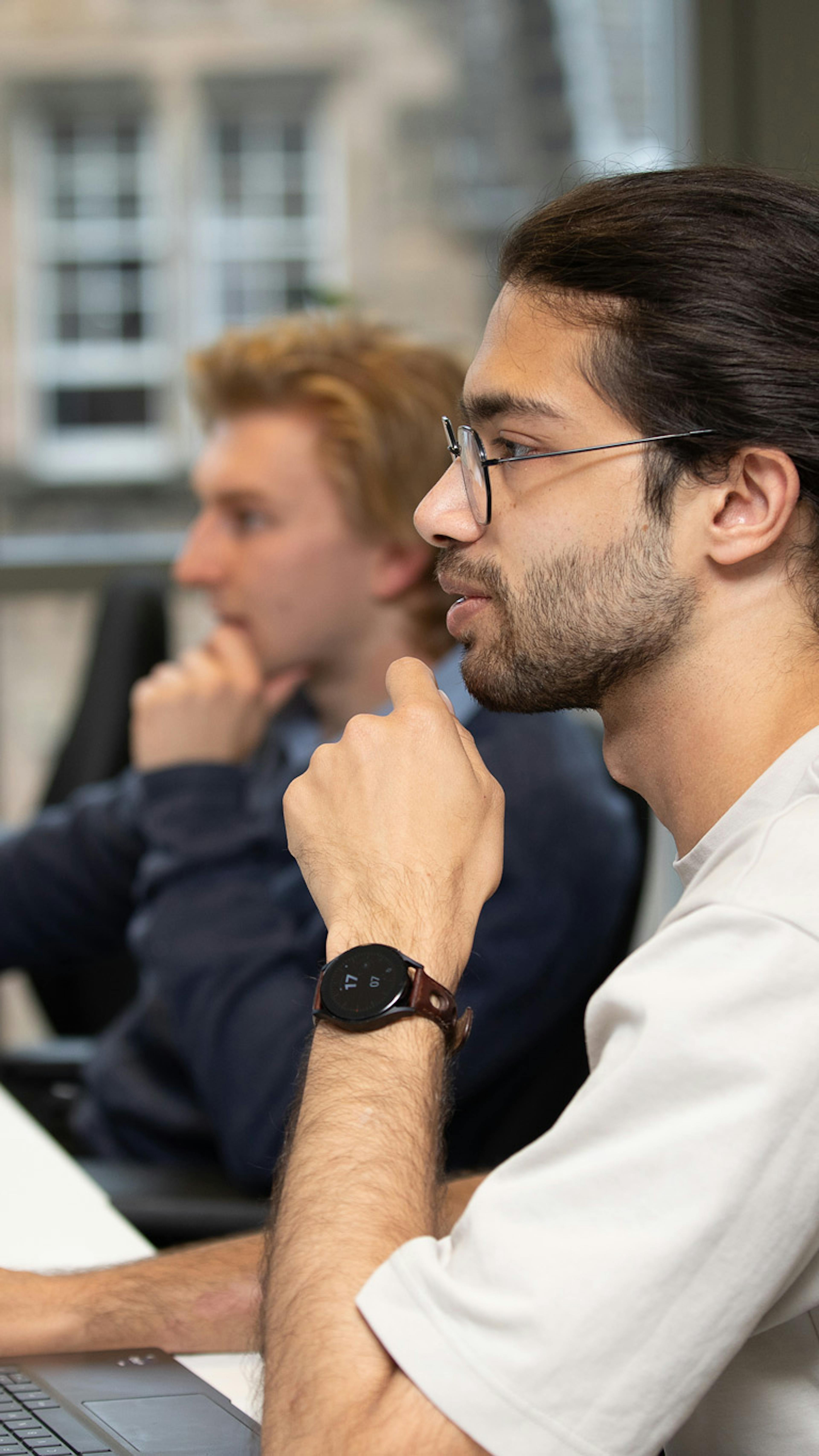 Two people in an office working at computers