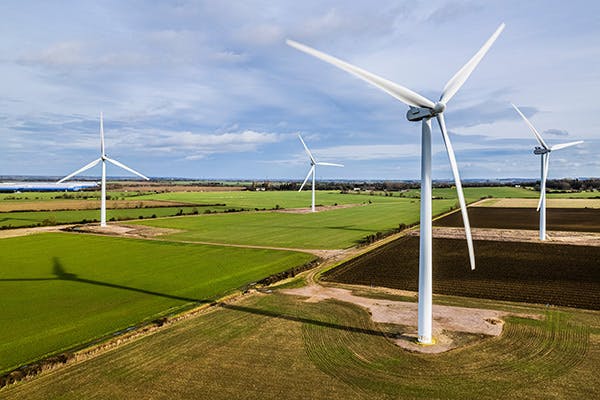 UK wind farm with four wind turbines in shot