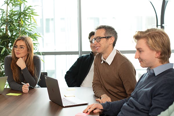 People in a meeting around a laptop