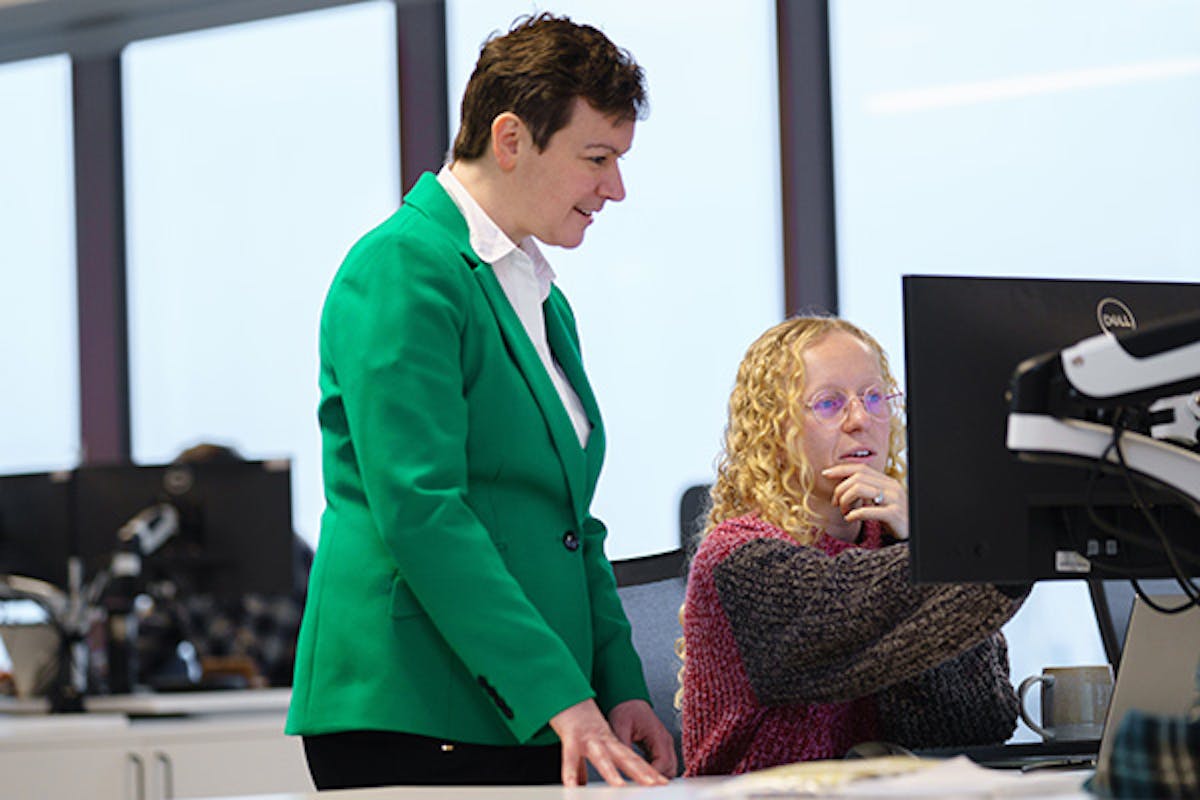 Two people looking at something on a computer screen