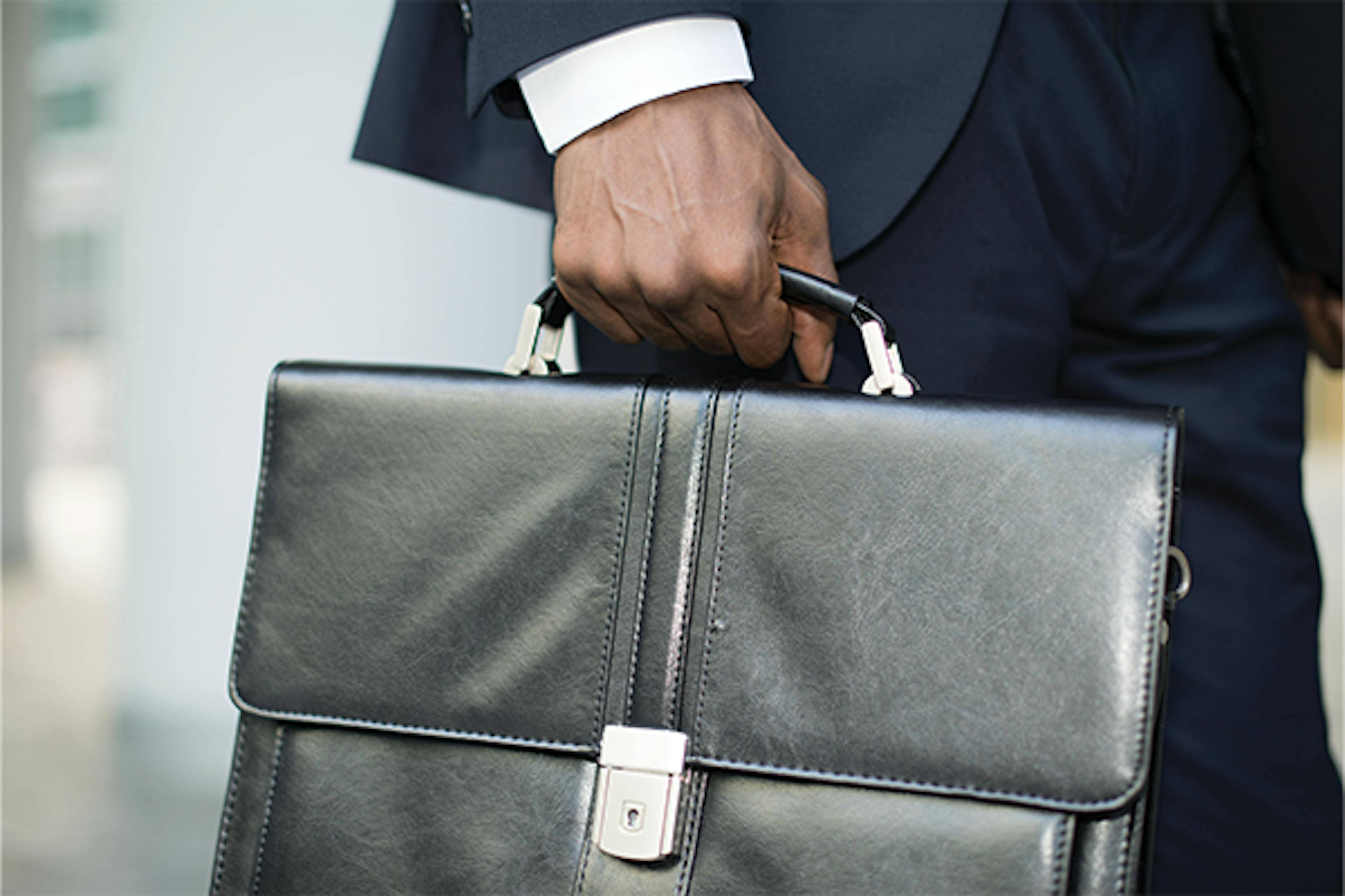 Individual holding a briefcase