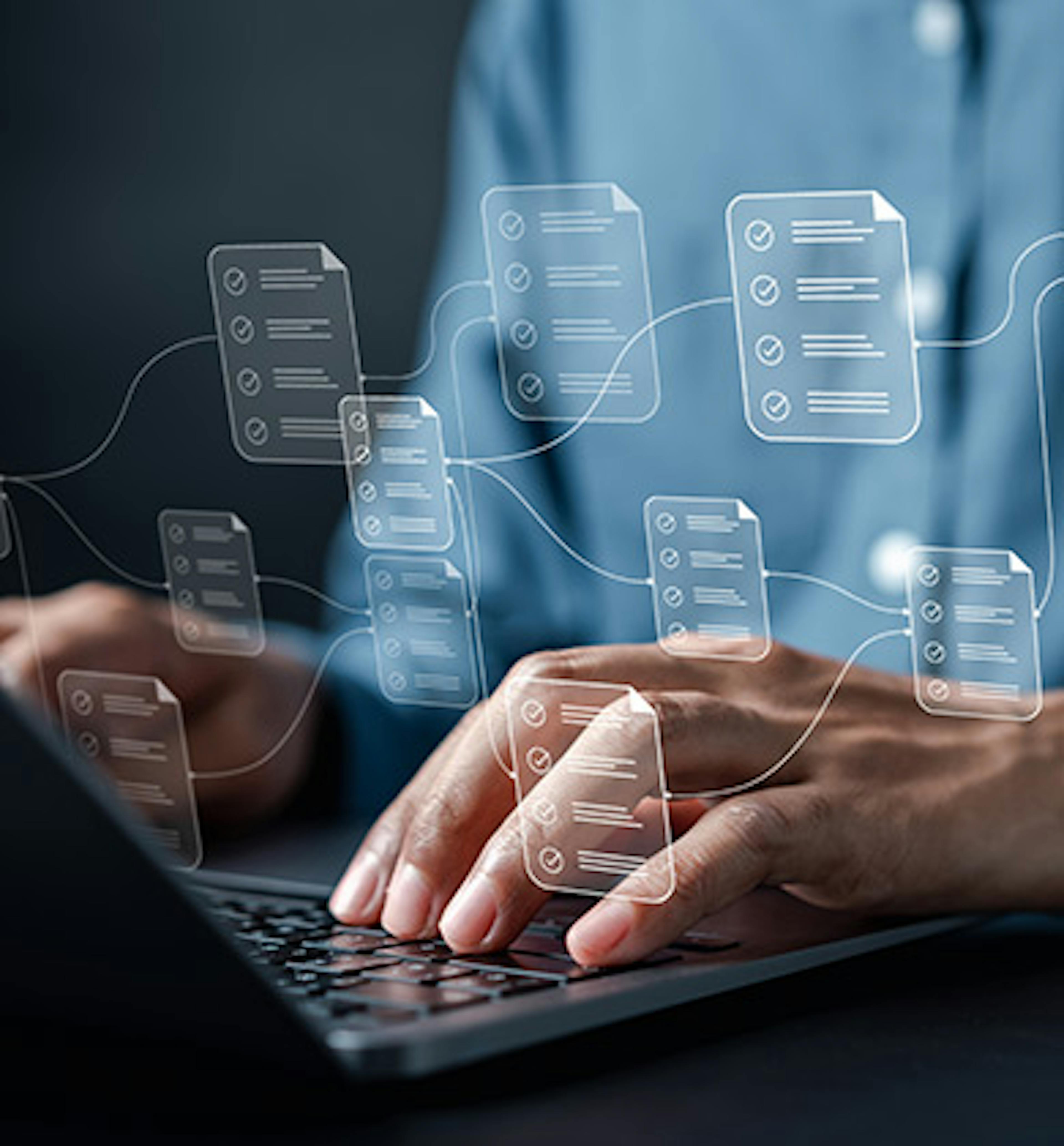 Person using a laptop keyboard with an overlay of interconnected documents