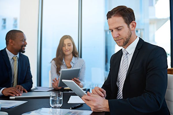 Man looking at a tablet computer in an office setting