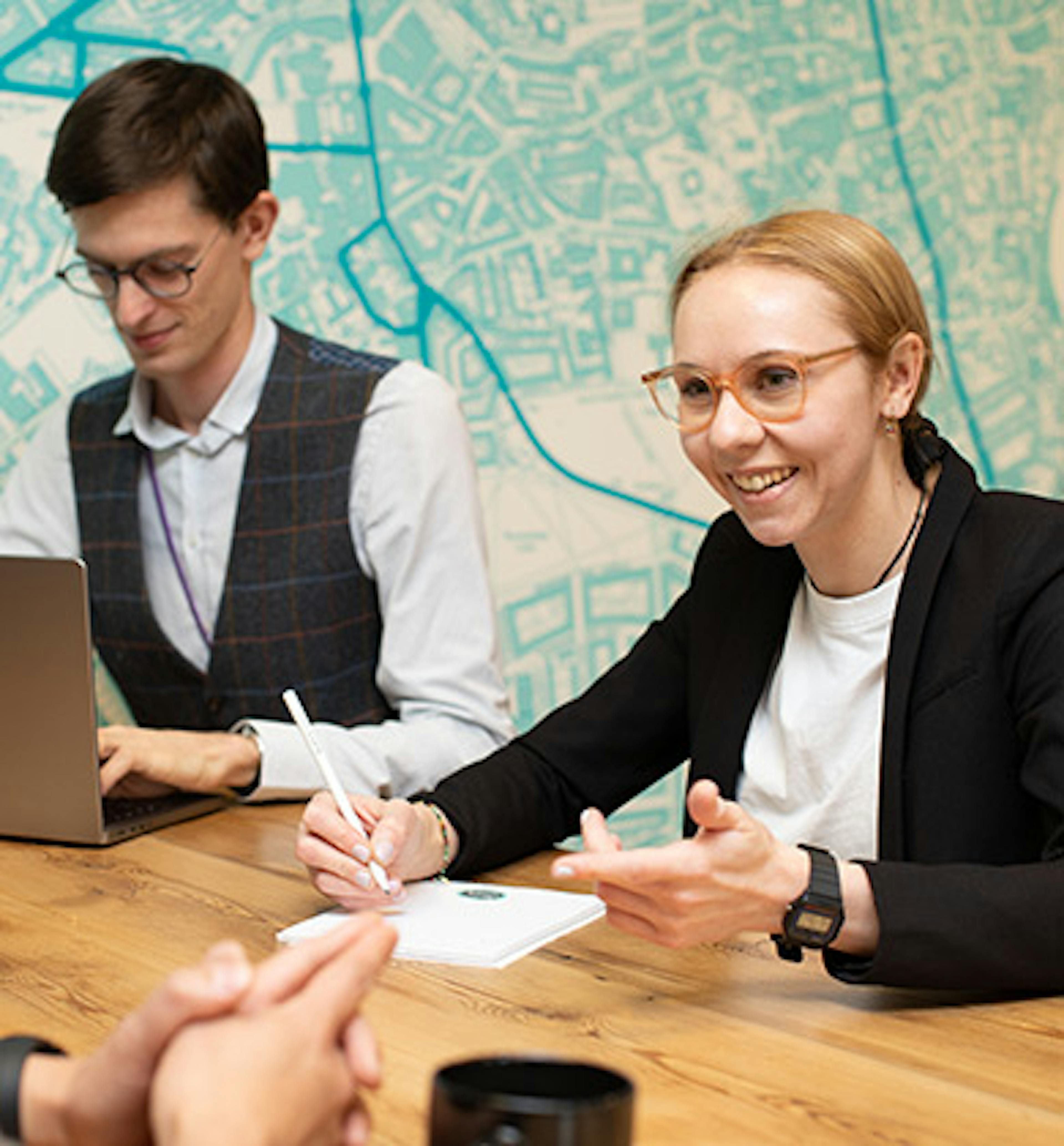 Three people having a meeting around a table