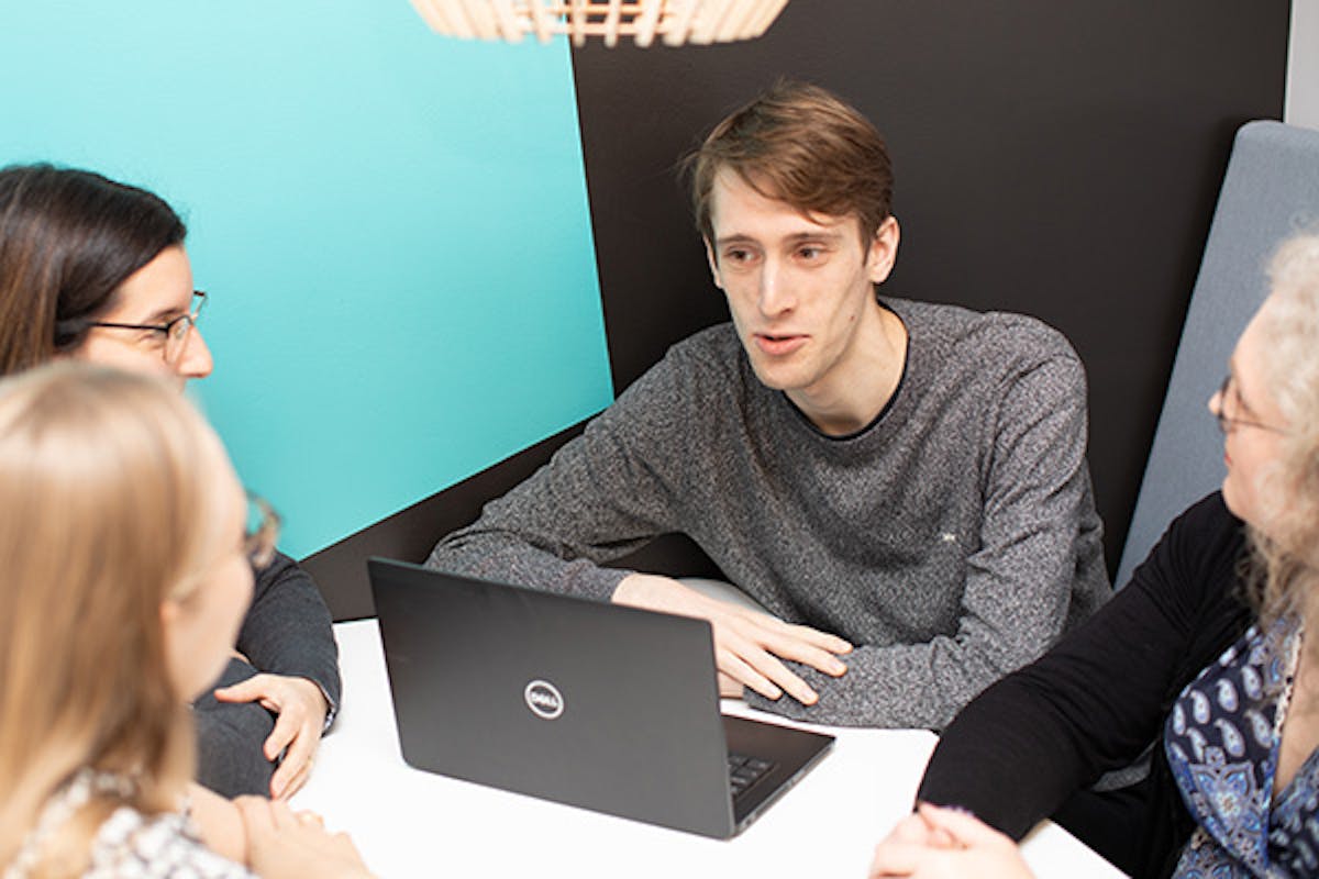 Four people in a meeting