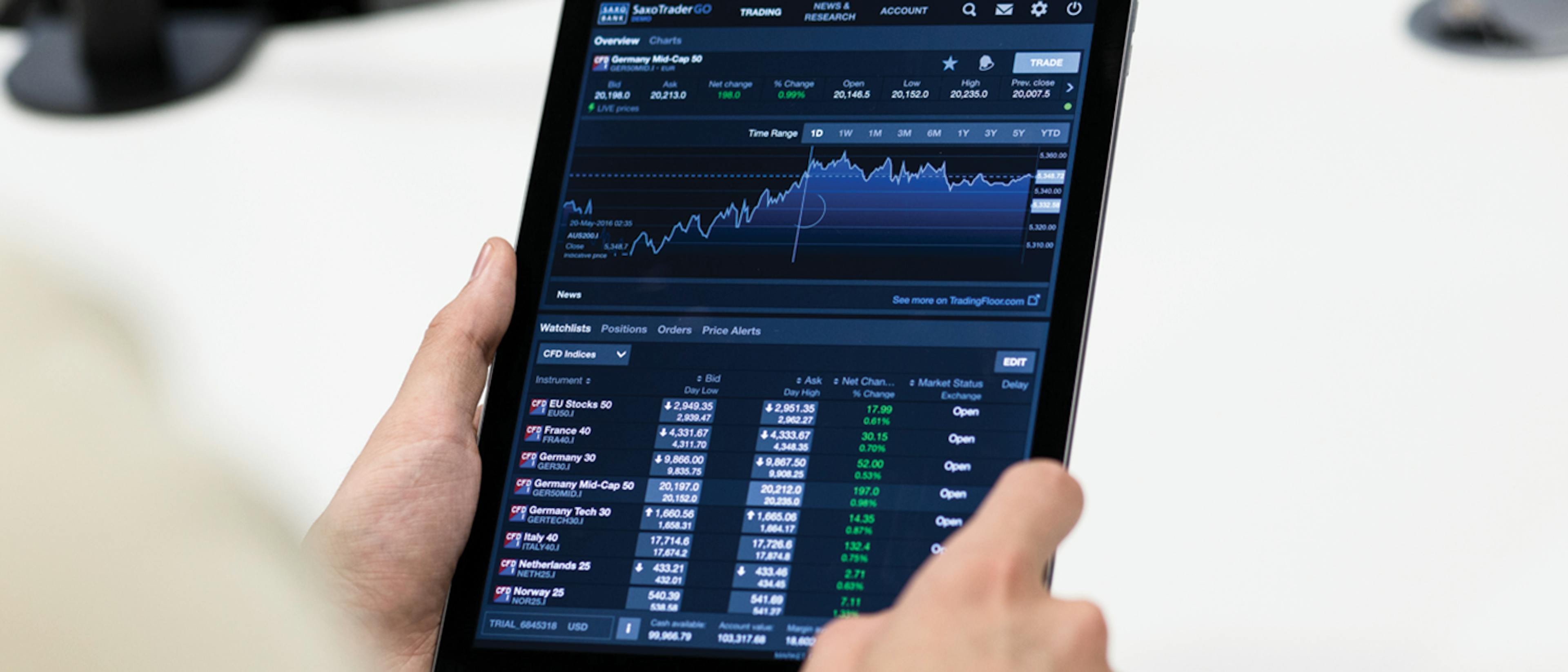 Person holding a tablet that is displaying a graph