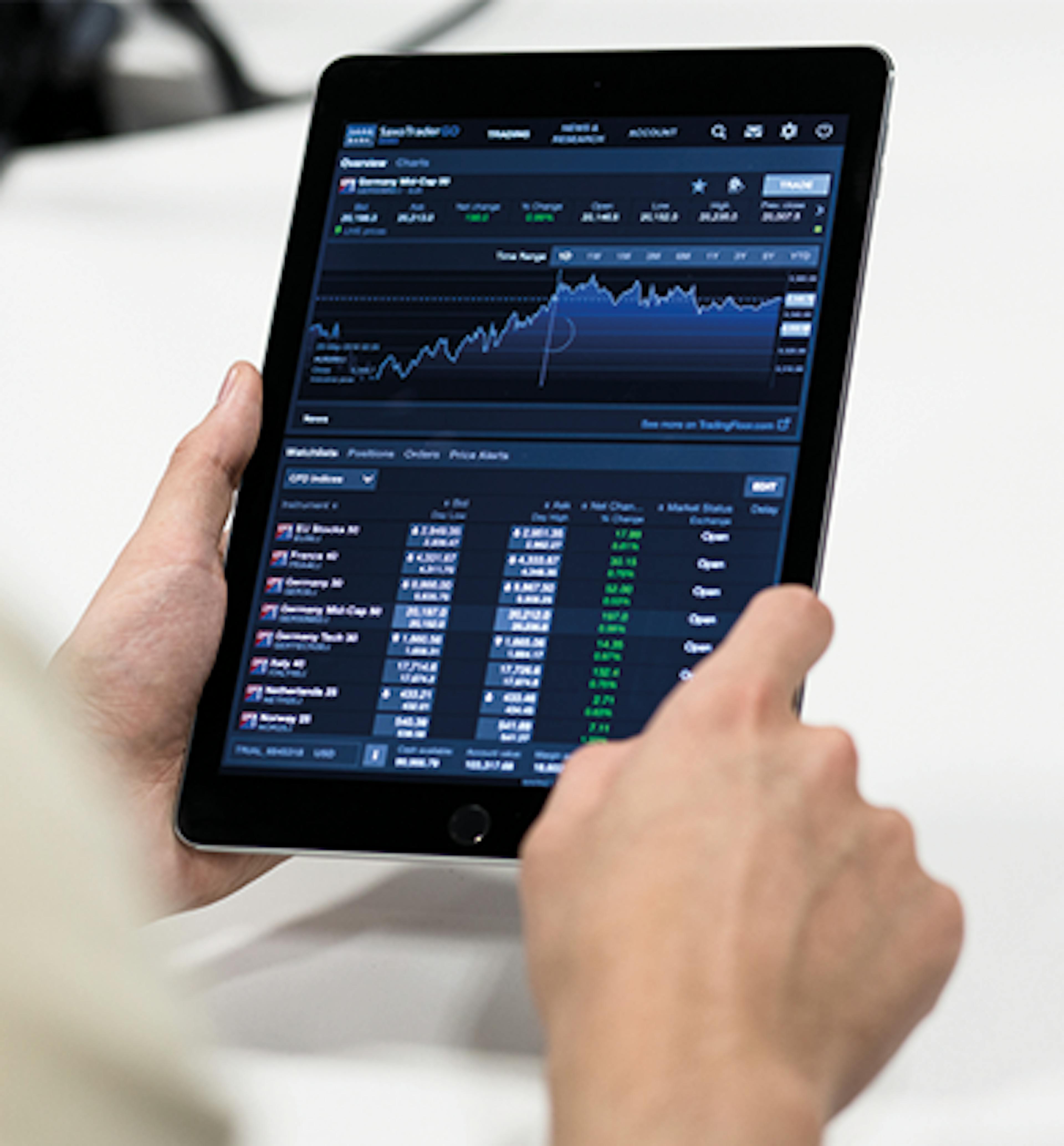 Person holding a tablet that is displaying a graph