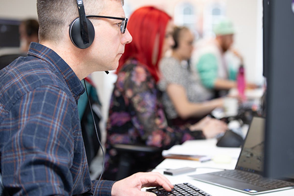 Software engineers working at the desks in an office