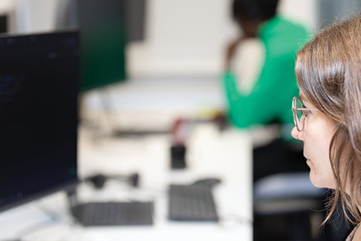 Worker sat behind computer monitor