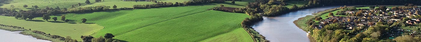 A river bending through English countryside on a sunny day