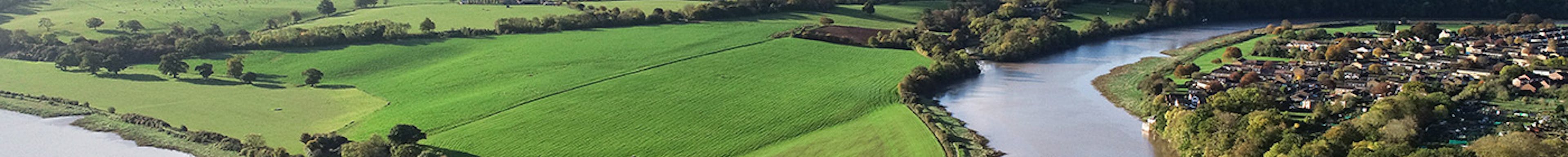 A river bending through English countryside on a sunny day