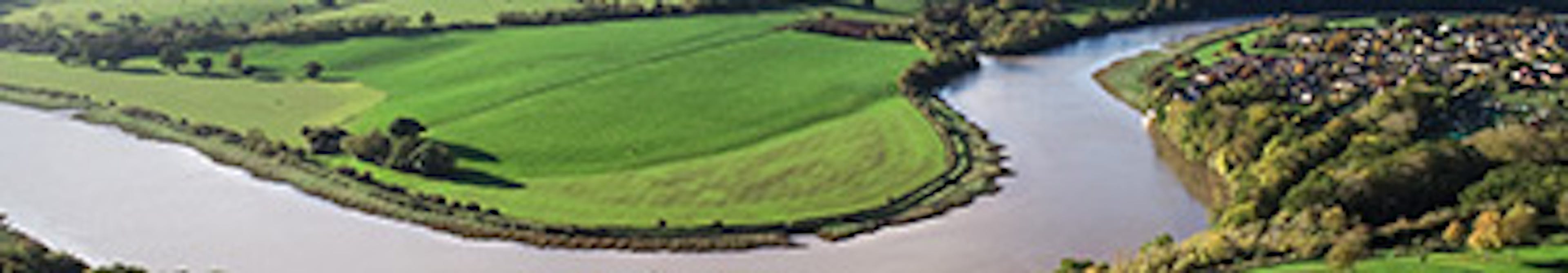 A river bending through English countryside on a sunny day