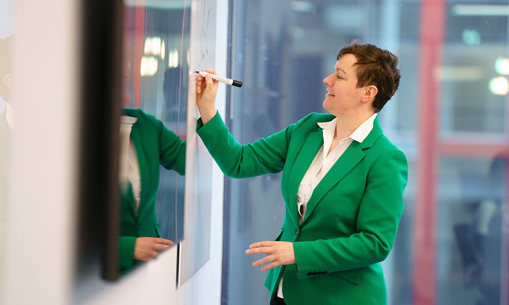 Woman writing on a whiteboard