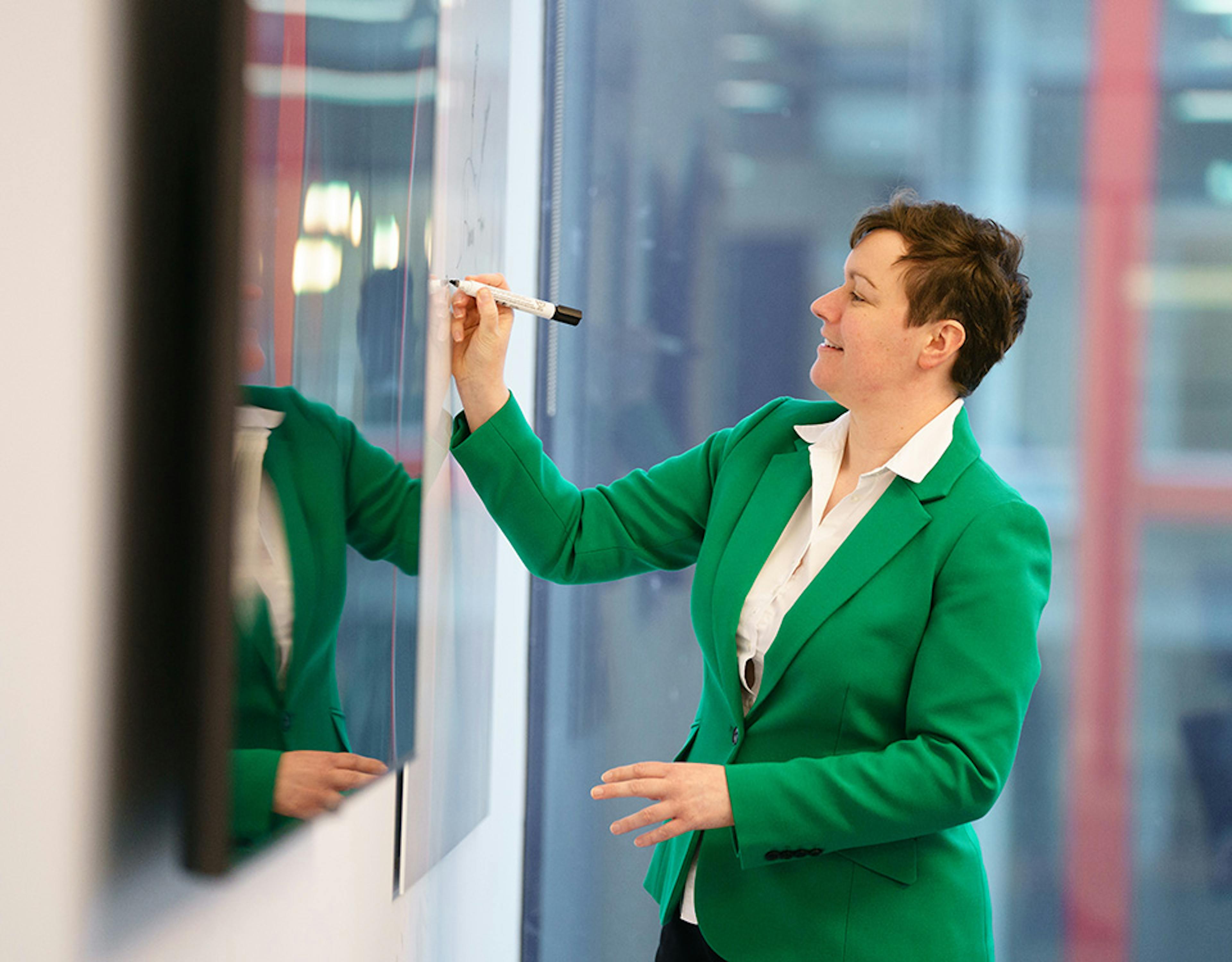 Woman writing on a whiteboard