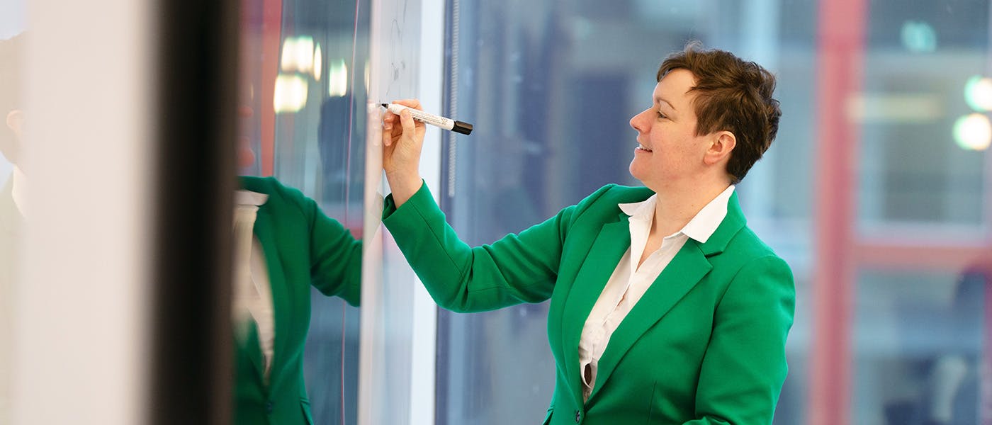 Woman writing on a whiteboard
