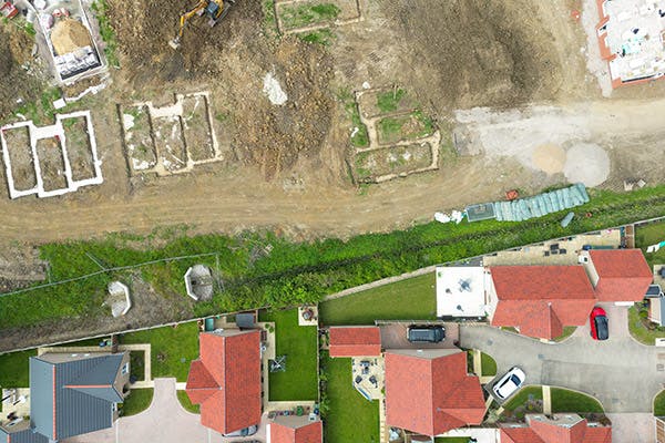 Aerial shot of a housing development, showing new-build houses and new plots being readied for development